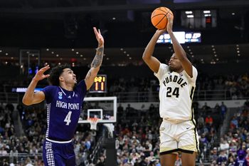 Mar 20, 2025; Providence, RI, USA; Purdue Boilermakers guard Gicarri Harris (24) shoots the ball against High Point Panthers guard D'Maurian Williams (4) during the second half at Amica Mutual Pavilion. Mandatory Credit: Eric Canha-Imagn Images