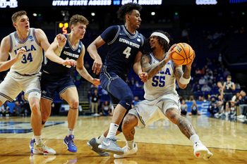 Mar 20, 2025; Lexington, KY, USA;  UCLA Bruins guard Skyy Clark (55) drives to the basket against Utah State Aggies guard Ian Martinez (4) during the second half in the first round of the NCAA Tournament at Rupp Arena. Mandatory Credit: Jordan Prather-Imagn Images