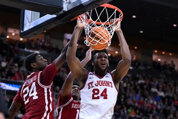 Mar 22, 2025; Providence, RI, USA; St. John's Red Storm forward Zuby Ejiofor (24) dunks against Arkansas Razorbacks forward Billy Richmond III (24) and guard Johnell Davis (1) during the second half of a second round men’s NCAA Tournament game at Amica Mutual Pavilion. Mandatory Credit: Brian Fluharty-Imagn Images