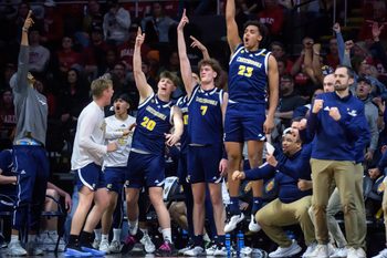 The Chattanooga bench erupts after a three-pointer gives them the lead over Bradley in the second half of their NIT quarterfinal basketball game Tuesday, March 25, 2025 at Carver Arena in Peoria. The Mocs advanced to the semifinals with a 67-65 win.