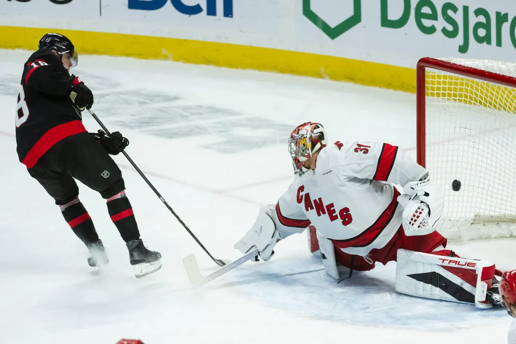 Apr 17, 2025; Ottawa, Ontario, CAN; Ottawa Senators center Tim Stutzle (18) scores against the Carolina Hurricanes goalie Frederik Andersen (31) in the third period at the Canadian Tire Centre. Mandatory Credit: Marc DesRosiers-Imagn Images
