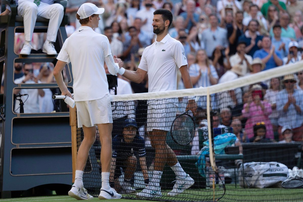 Jul 11, 2025; Wimbledon, United Kingdom; Jannik Sinner of Italy at the net with Novak Djokovic of Serbia after their match on day 12 at All England Lawn Tennis and Croquet Club. Mandatory Credit: Susan Mullane-Imagn Images