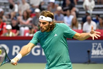 Jul 30, 2025; Toronto, ON, Canada;  Stefanos Tsitsipas (GRE) plays a shot against Christopher O'Connell (AUS) during second round play at Sobeys Stadium. Mandatory Credit: Dan Hamilton-Imagn Images