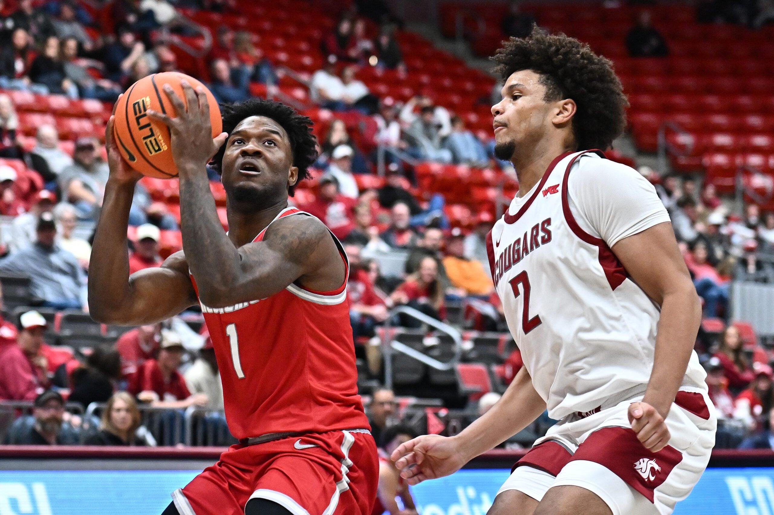 Oct 25, 2025; Pullman, WA, USA; New Mexico Lobos guard Deyton Albury (1) shoots the ball against Washington State Cougars forward Eemeli Yalaho (2) in the second half at Friel Court at Beasley Coliseum. Mandatory Credit: James Snook-Imagn Images