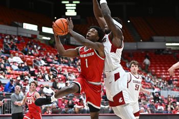 Oct 25, 2025; Pullman, WA, USA; New Mexico Lobos guard Deyton Albury (1) shoots the ball against Washington State Cougars forward Emmanuel Ugbo (0) in the second half at Friel Court at Beasley Coliseum. Mandatory Credit: James Snook-Imagn Images
