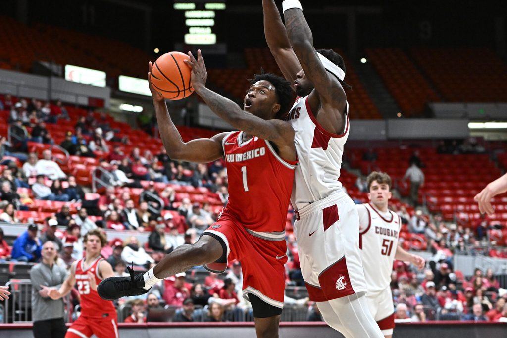 Oct 25, 2025; Pullman, WA, USA; New Mexico Lobos guard Deyton Albury (1) shoots the ball against Washington State Cougars forward Emmanuel Ugbo (0) in the second half at Friel Court at Beasley Coliseum. Mandatory Credit: James Snook-Imagn Images