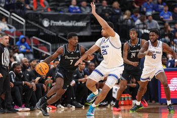 Nov 3, 2025; Newark, New Jersey, USA; Saint Peter's Peacocks guard Elijah Perkins (7) dribbles against Seton Hall Pirates center Najai Hines (25) during the second half at Prudential Center. Mandatory Credit: Vincent Carchietta-Imagn Images