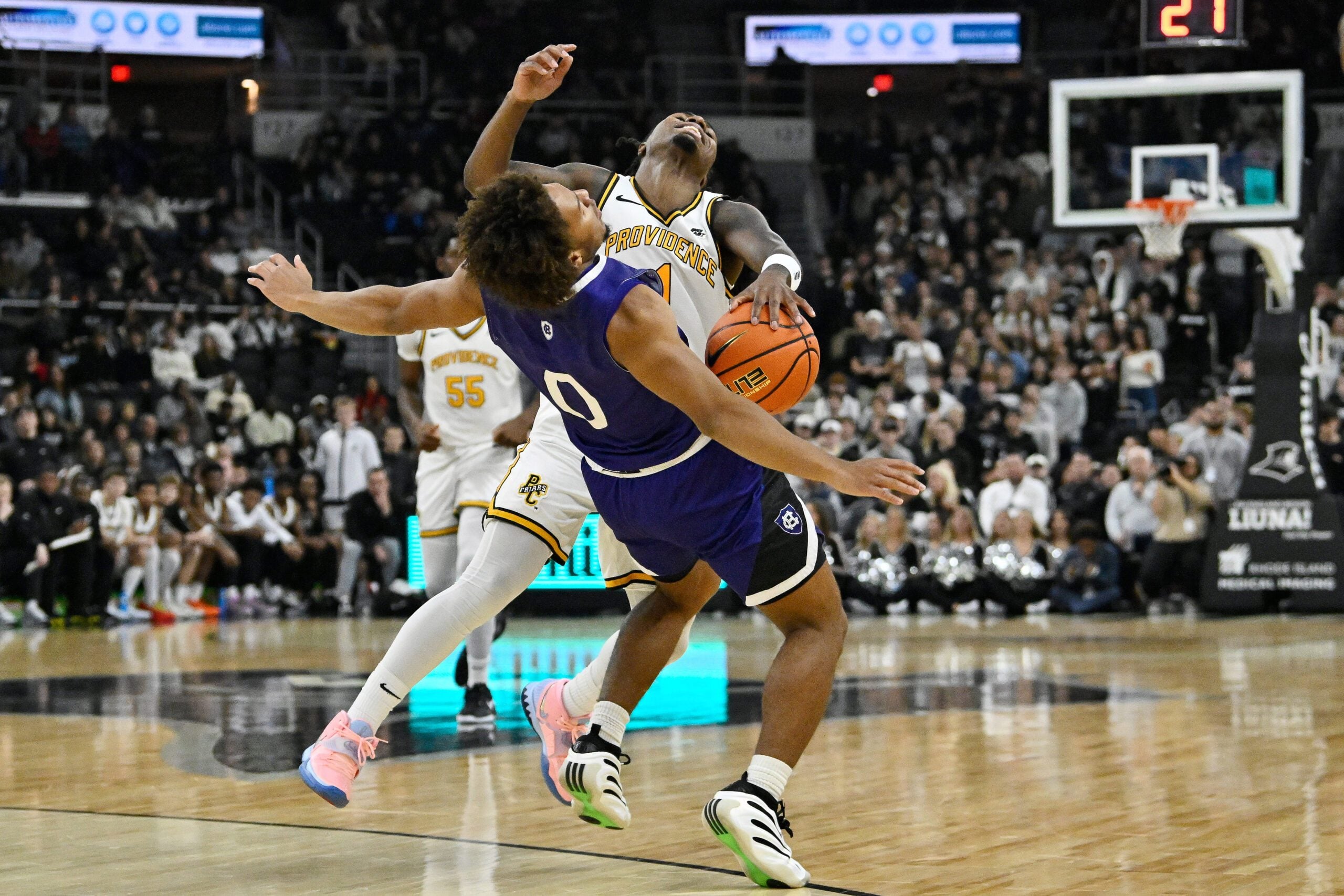 Nov 3, 2025; Providence, Rhode Island, USA; Providence Friars guard Jason Edwards (1) collides with Holy Cross Crusaders guard Tyler Boston (0) during the first half at Amica Mutual Pavilion. Mandatory Credit: Eric Canha-Imagn Images