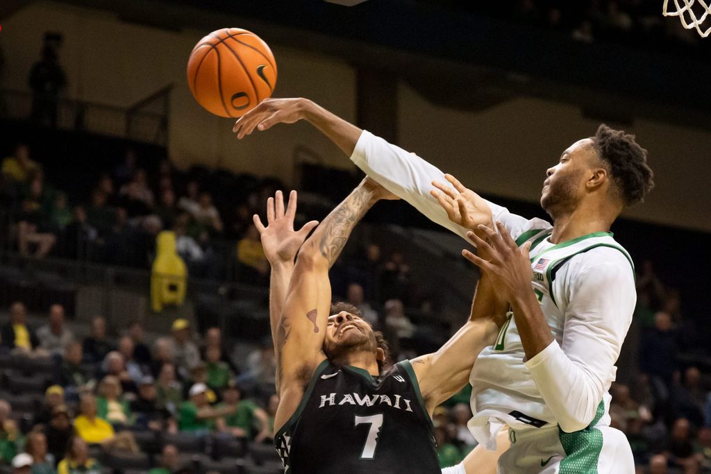 Oregon forward Kwame Evans Jr., right, fouls Hawaii guard Isaiah Kerr on a block as the Oregon Ducks host the Hawaii Rainbow Warriors on Nov. 4, 2025, at Matthew Knight Arena in Eugene, Oregon.