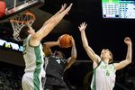 Oregon center Nate Bittle, left, and Oregon forward Oleksandr Kobzystyi block a shot by Hawaii guard Dre Bullock as the Oregon Ducks host the Hawaii Rainbow Warriors on Nov. 4, 2025, at Matthew Knight Arena in Eugene, Oregon.