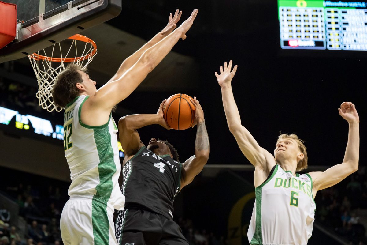 Oregon center Nate Bittle, left, and Oregon forward Oleksandr Kobzystyi block a shot by Hawaii guard Dre Bullock as the Oregon Ducks host the Hawaii Rainbow Warriors on Nov. 4, 2025, at Matthew Knight Arena in Eugene, Oregon.