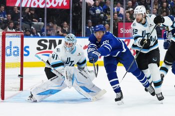 Nov 5, 2025; Toronto, Ontario, CAN; Toronto Maple Leafs center Dakota Joshua (81) battles for the puck with Utah Mammoth center Kevin Stenlund (82) during the third period at Scotiabank Arena. Mandatory Credit: Nick Turchiaro-Imagn Images