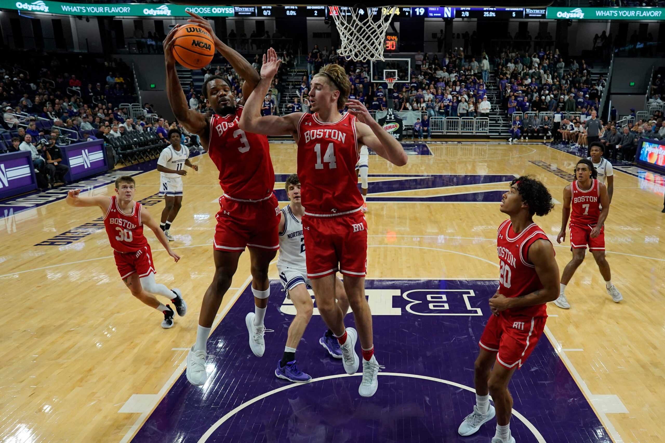 Nov 7, 2025; Evanston, Illinois, USA; Boston University Terriers forward Malcolm Chimezie (3) grabs a rebound against the Northwestern Wildcats forward Ben Defty (14) during the first half at Welsh-Ryan Arena. Mandatory Credit: David Banks-Imagn Images