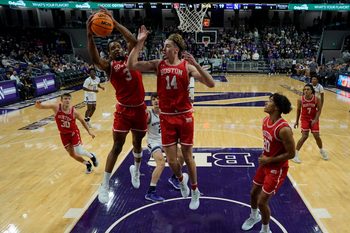 Nov 7, 2025; Evanston, Illinois, USA; Boston University Terriers forward Malcolm Chimezie (3) grabs a rebound against the Northwestern Wildcats forward Ben Defty (14) during the first half at Welsh-Ryan Arena. Mandatory Credit: David Banks-Imagn Images