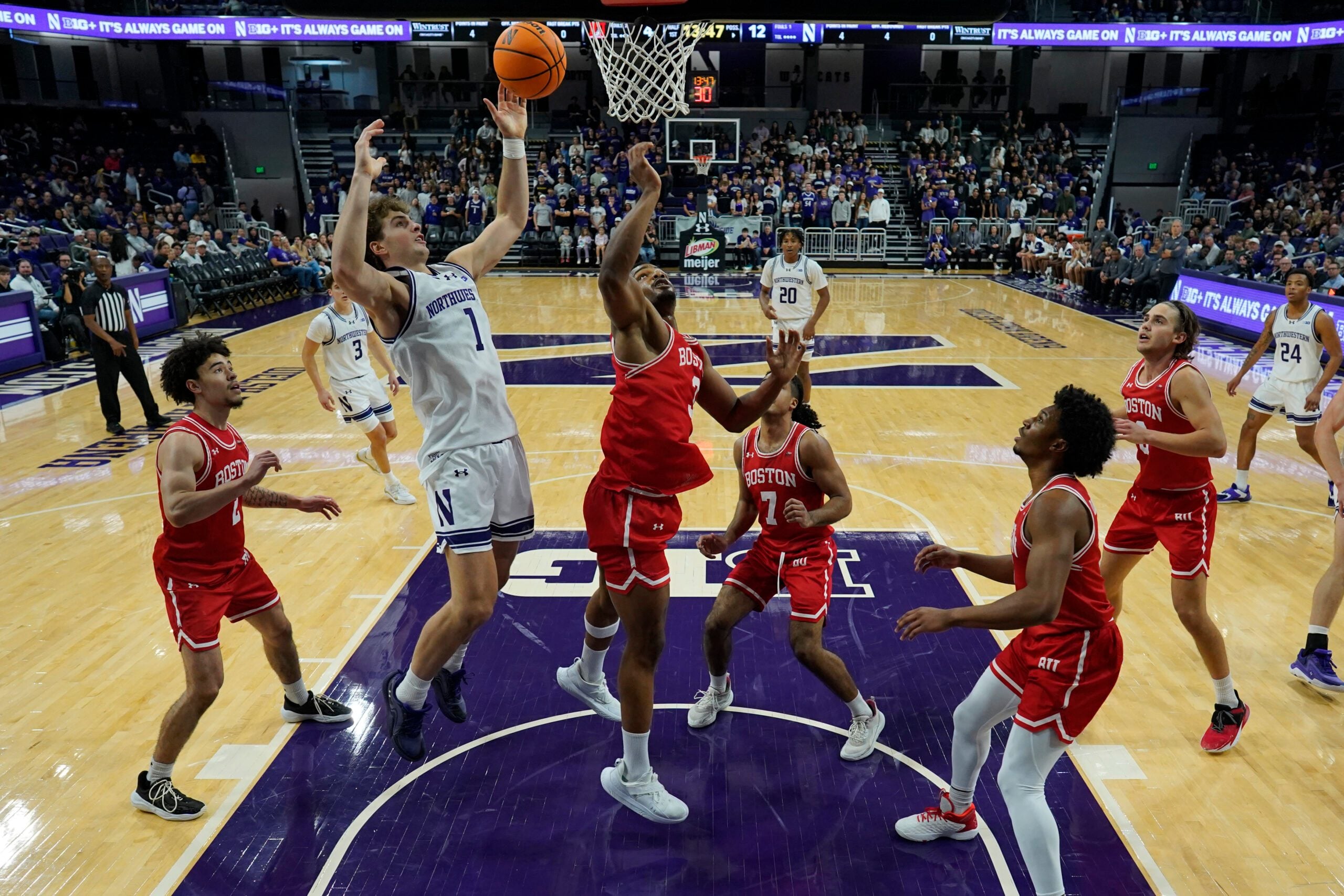 Nov 7, 2025; Evanston, Illinois, USA; Boston University Terriers forward Malcolm Chimezie (3) defends Northwestern Wildcats forward Tyler Kropp (1) during the first half at Welsh-Ryan Arena. Mandatory Credit: David Banks-Imagn Images