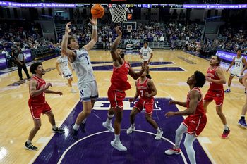 Nov 7, 2025; Evanston, Illinois, USA; Boston University Terriers forward Malcolm Chimezie (3) defends Northwestern Wildcats forward Tyler Kropp (1) during the first half at Welsh-Ryan Arena. Mandatory Credit: David Banks-Imagn Images