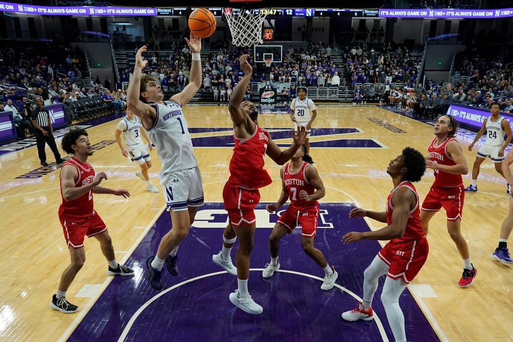 Nov 7, 2025; Evanston, Illinois, USA; Boston University Terriers forward Malcolm Chimezie (3) defends Northwestern Wildcats forward Tyler Kropp (1) during the first half at Welsh-Ryan Arena. Mandatory Credit: David Banks-Imagn Images