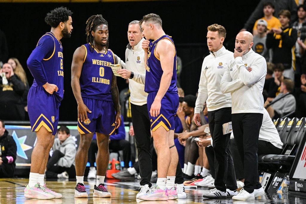 Nov 7, 2025; Iowa City, Iowa, USA; Western Illinois Leathernecks head coach Chad Boudreau (far right) reacts during a timeout with his coaches and guard Tyran Cook (0) and guard Lucas Lorenzen (3) and forward Isaiah Griffin (far left) during the first half against the Iowa Hawkeyes at Carver-Hawkeye Arena. Mandatory Credit: Jeffrey Becker-Imagn Images