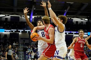 Nov 7, 2025; Evanston, Illinois, USA; Northwestern Wildcats forward Tre Singleton (8) and forward Tyler Kropp (1) defend Boston University Terriers forward Ben Defty (14) during the second half at Welsh-Ryan Arena. Mandatory Credit: David Banks-Imagn Images