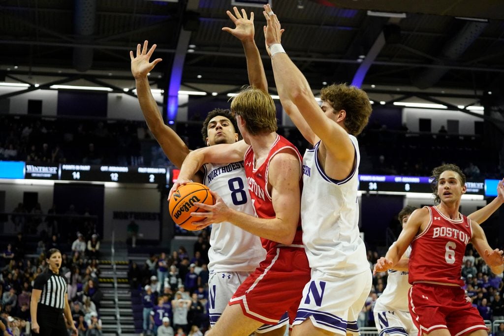 Nov 7, 2025; Evanston, Illinois, USA; Northwestern Wildcats forward Tre Singleton (8) and forward Tyler Kropp (1) defend Boston University Terriers forward Ben Defty (14) during the second half at Welsh-Ryan Arena. Mandatory Credit: David Banks-Imagn Images