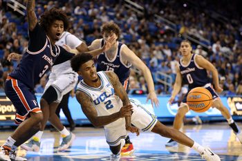 Nov 7, 2025; Los Angeles, California, USA;  UCLA Bruins guard Donovan Dent (2) passes the ball during the first half against the Pepperdine Waves at Pauley Pavilion presented by Wescom Financial. Mandatory Credit: Kiyoshi Mio-Imagn Images