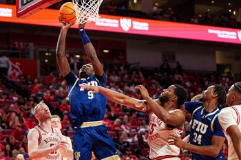 Nov 8, 2025; Lincoln, Nebraska, USA; Florida International Panthers forward Eric Dibami (9) shoots the ball against Nebraska Cornhuskers forward Rienk Mast (51) and forward Jared Garcia (15) during the second half at Pinnacle Bank Arena. Mandatory Credit: Dylan Widger-Imagn Images