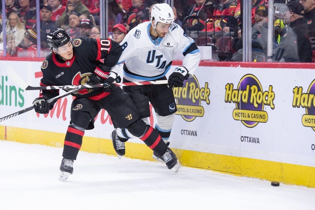 Nov 9, 2025; Ottawa, Ontario, CAN; Ottawa Senators defenseman Jordan Spence (10) battles with Utah Mammoth center Nick Schmaltz (8) in the second period at the Canadian Tire Centre. Mandatory Credit: Marc DesRosiers-IMAGN Images