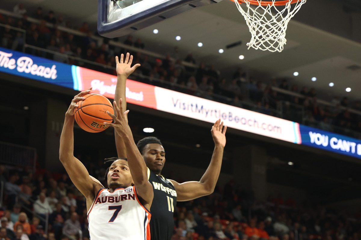 Nov 11, 2025; Auburn, Alabama, USA;  Auburn Tigers guard Keyshawn Hall (7) grabs a rebound from Wofford Terriers guard Kahmare Holmes (11) during the first half at Neville Arena. Mandatory Credit: John Reed-Imagn Images