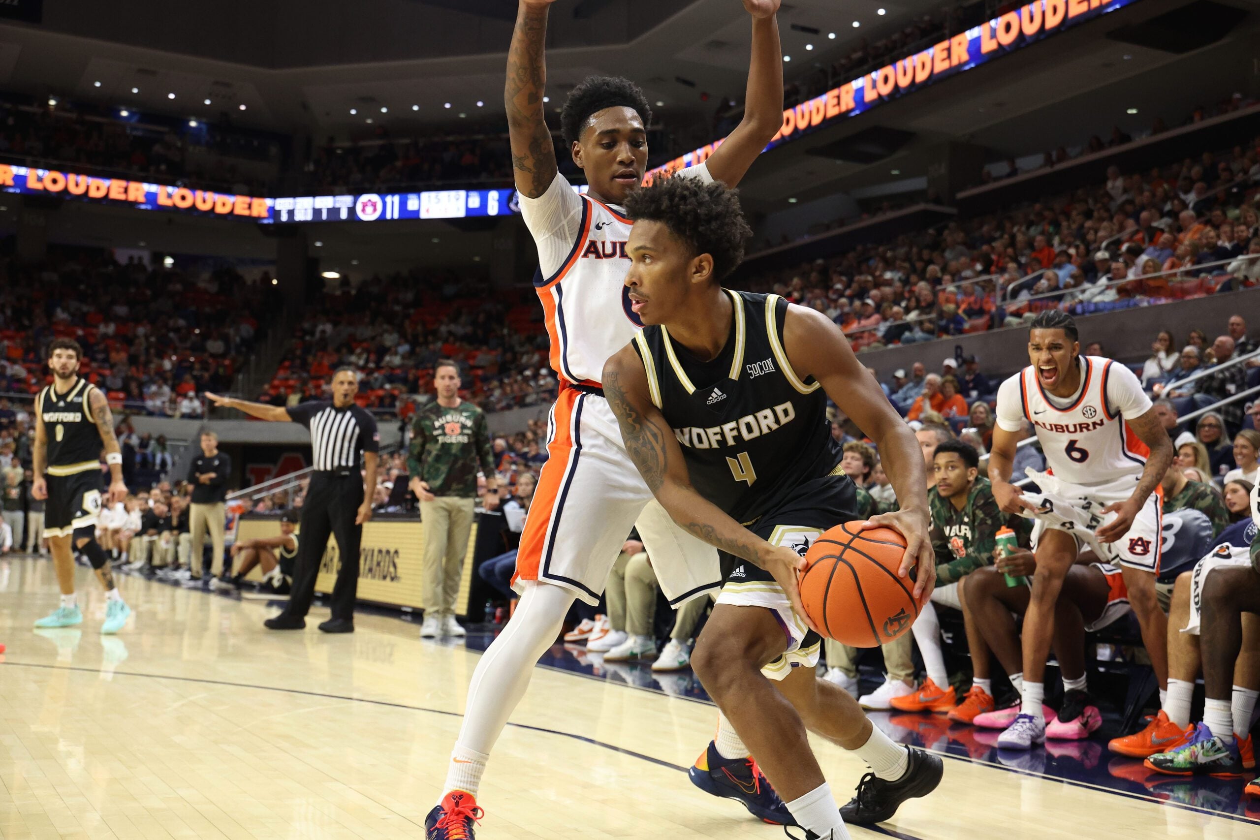 Nov 11, 2025; Auburn, Alabama, USA;  Wofford Terriers guard Chace Watley (4) looks for help as Auburn Tigers guard Tahaad Pettiford (0) defends during the first half at Neville Arena. Mandatory Credit: John Reed-Imagn Images