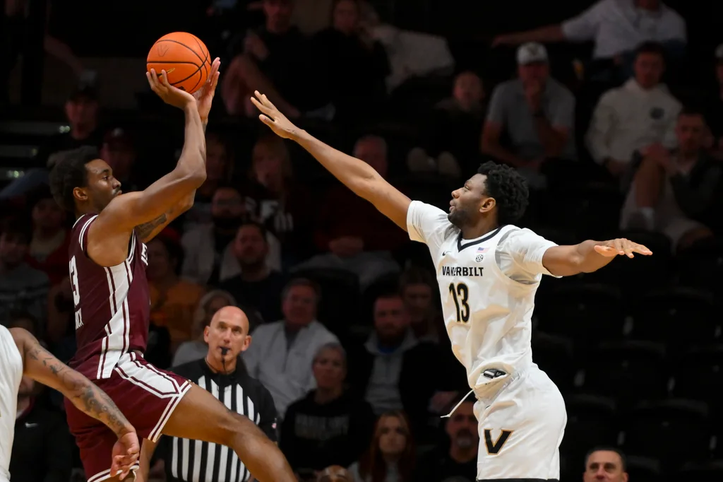 Nov 12, 2025; Nashville, Tennessee, USA; Eastern Kentucky Colonels forward Montavious Myrick (13) shoots over Vanderbilt Commodores forward Jalen Washington (13) during the second half at Memorial Gymnasium. Mandatory Credit: Steve Roberts-Imagn Images