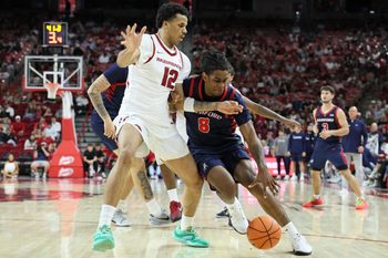 Nov 14, 2025; Fayetteville, Arkansas, USA; Samford Bulldogs guard Zion Wilburn (8) drives against Arkansas Razorbacks forward Malique Ewin (12) during the first half at Bud Walton Arena. Mandatory Credit: Nelson Chenault-Imagn Images