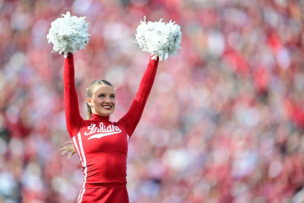 Nov 15, 2025; Bloomington, Indiana, USA; A Indiana Hoosiers cheerleader performs during a timeout in during the second quarter of the game against the Wisconsin Badgers at Memorial Stadium. Mandatory Credit: Marc Lebryk-Imagn Images