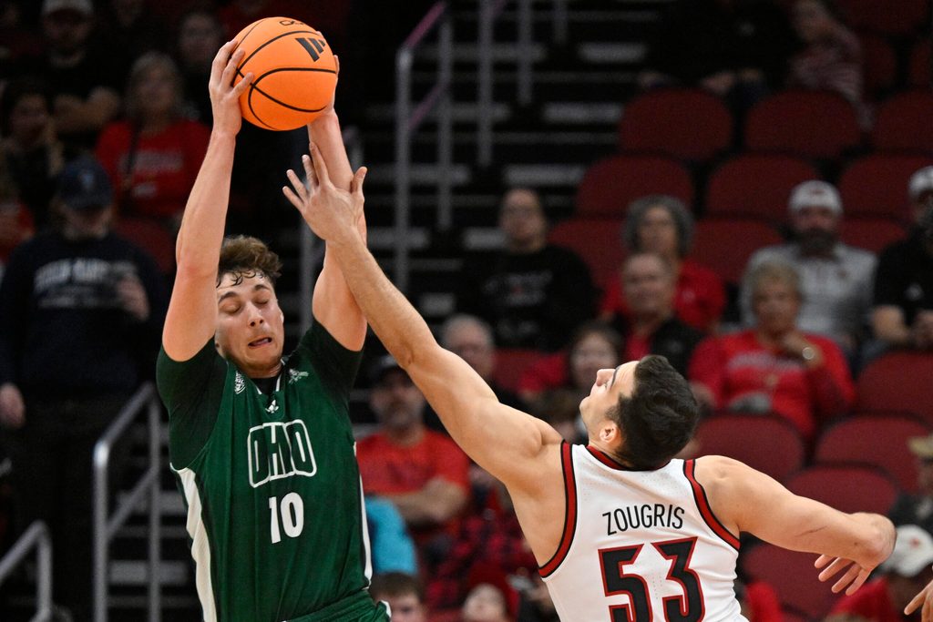 Nov 15, 2025; Louisville, Kentucky, USA; Ohio Bobcats forward Aidan Hadaway (10) battles Louisville Cardinals forward Vangelis Zougris (53) for a rebound during the first half at KFC Yum! Center. Mandatory Credit: Jamie Rhodes-Imagn Images