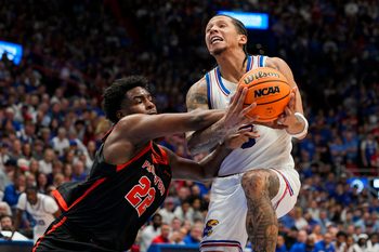 Nov 15, 2025; Lawrence, Kansas, USA; Kansas Jayhawks guard Tre White (3) is fouled while shooting against Princeton Tigers guard Dalen Davis (22) during the first half at Allen Fieldhouse. Mandatory Credit: Jay Biggerstaff-Imagn Images