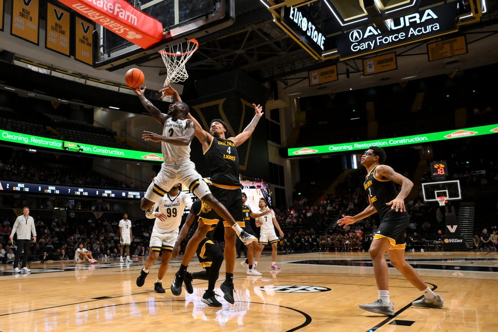 Nov 15, 2025; Nashville, Tennessee, USA; Vanderbilt Commodores guard Duke Miles (2) goes under the arms of Arkansas-Pine Bluff Golden Lions forward Jaquan Scott (4) during the second half at Memorial Gymnasium. Mandatory Credit: Steve Roberts-Imagn Images