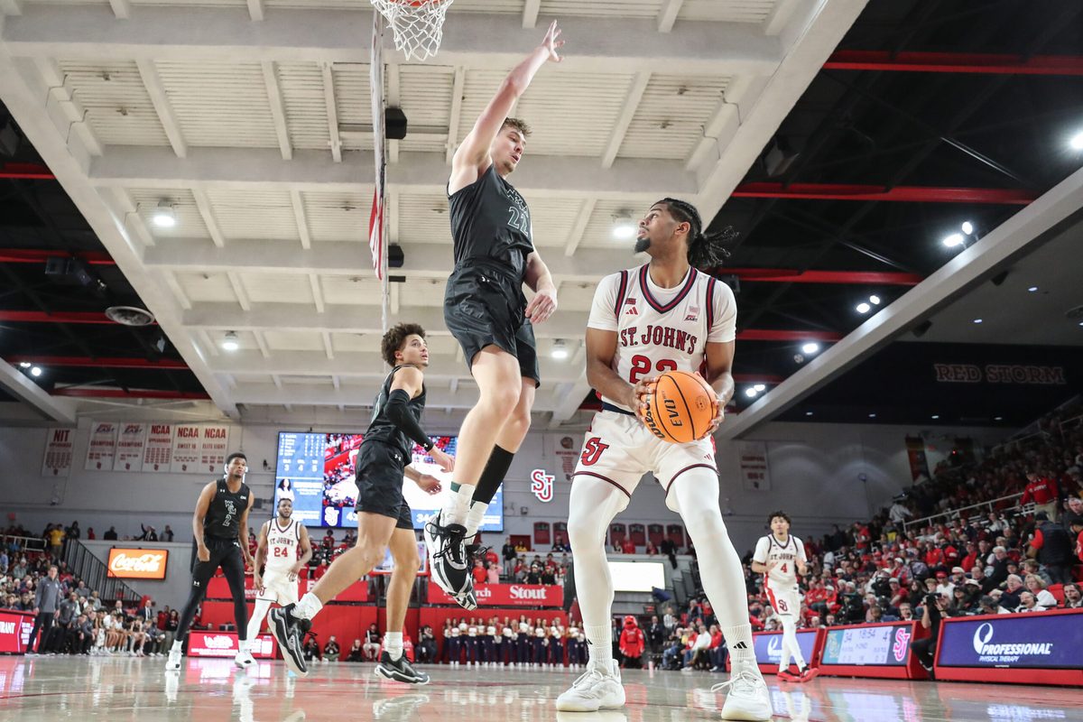 Nov 15, 2025; Queens, New York, USA; St. John's Red Storm forward Bryce Hopkins (23) looks to post up against William & Mary Tribe forward Kilian Brockhoff (22) in the second half at Carnesecca Arena. Mandatory Credit: Wendell Cruz-Imagn Images