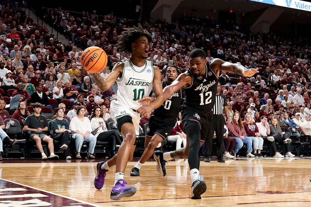 Nov 21, 2025; College Station, Texas, USA; Manhattan Jaspers guard Quron Elliott (10) attempt to pass the ball as Texas A&M Aggies forward Rashaun Agee (12) defends during the second half at Reed Arena. Mandatory Credit: Maria Lysaker-Imagn Images