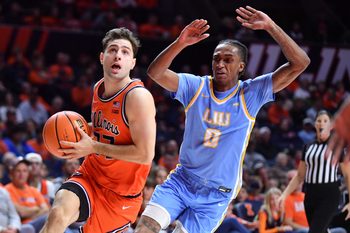 Nov 22, 2025; Champaign, Illinois, USA; Illinois Fighting Illini guard Mihailo Petrovic (77) drives past Long Island University Sharks guard Malachi Davis (0) during the first half at State Farm Center. Mandatory Credit: Ron Johnson-Imagn Images
