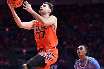 Nov 22, 2025; Champaign, Illinois, USA;  Illinois Fighting Illini guard Mihailo Petrovic (77) drives to the basket during the first half against the Long Island University Sharks at State Farm Center. Mandatory Credit: Ron Johnson-Imagn Images