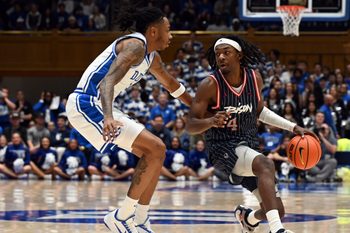 Nov 23, 2025; Durham, North Carolina, USA;  Howard Bison guard Alex Cotton (4) controls the ball in front of Duke Blue Devils forward Isaiah Evans (3) during the first half at Cameron Indoor Stadium. Mandatory Credit: Rob Kinnan-Imagn Images