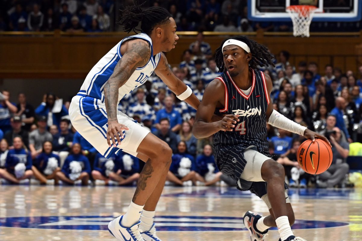 Nov 23, 2025; Durham, North Carolina, USA; Howard Bison guard Alex Cotton (4) controls the ball in front of Duke Blue Devils forward Isaiah Evans (3) during the first half at Cameron Indoor Stadium. Mandatory Credit: Rob Kinnan-Imagn Images