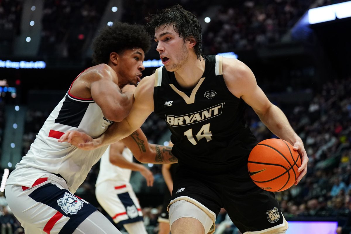 Nov 23, 2025; Hartford, Connecticut, USA; Bryant Bulldogs forward Keegan Harvey (14) drives the ball against UConn Huskies forward Jaylin Stewart (3) in the first half at Peoples Bank Arena. Mandatory Credit: David Butler II-Imagn Images