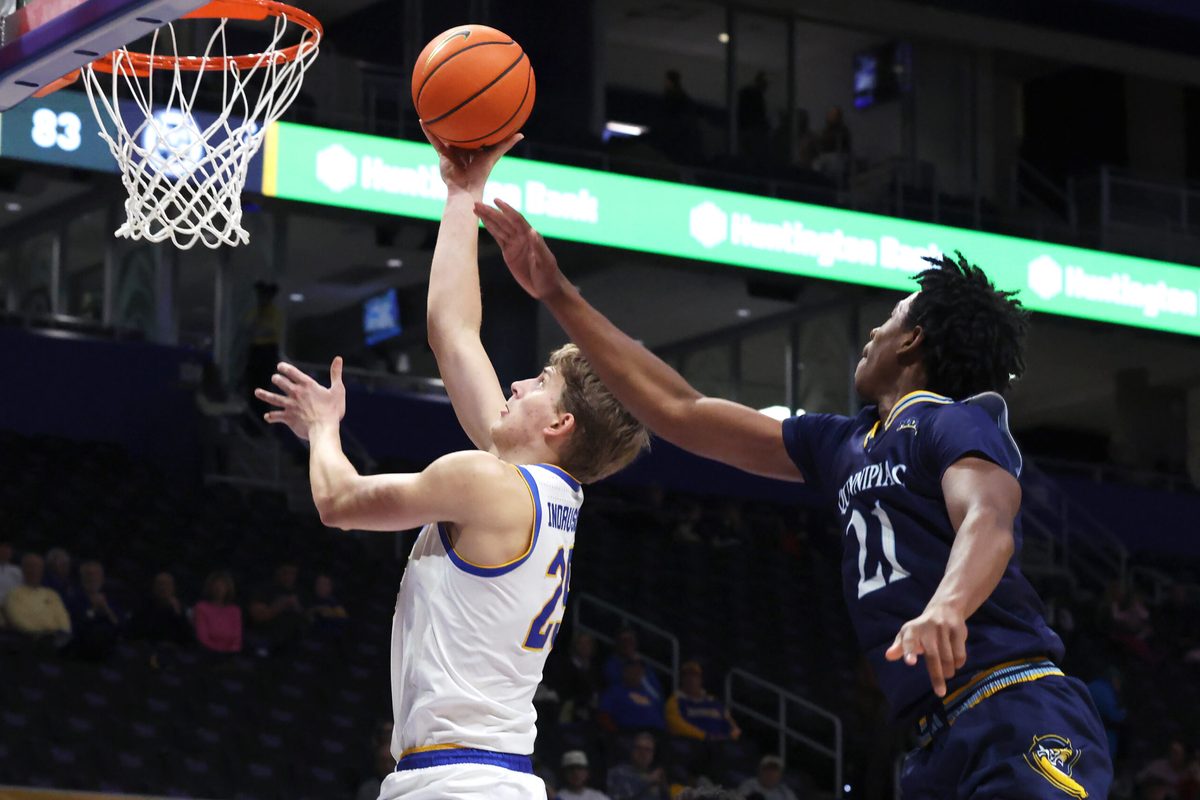 Nov 23, 2025; Pittsburgh, Pennsylvania, USA; Pittsburgh Panthers guard Nojus Indrusaitis (25) shoots against Quinnipiac Bobcats guard Keith Mcknight (21) during the second half at the Petersen Events Center. Mandatory Credit: Charles LeClaire-Imagn Images