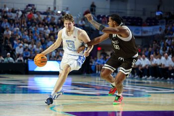 Nov 25, 2025; Fort Myers, Florida, USA; North Carolina Tar Heels center Henri Veesaar (13) drives to th basket guarded by St. Bonaventure Bonnies forward Frank Mitchell (00) in the first half at Suncoast Credit Union Arena. Mandatory Credit: Nathan Ray Seebeck-Imagn Images
