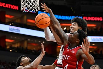 Nov 26, 2025; Louisville, Kentucky, USA;  NJIT Highlanders guard Ari Fulton (24) battles Louisville Cardinals forward Sananda Fru (13) for a rebound during the second half at KFC Yum! Center. Louisville defeated New Jersey Tech 104-47. Mandatory Credit: Jamie Rhodes-Imagn Images