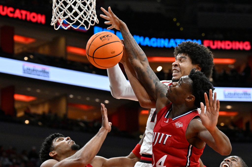 Nov 26, 2025; Louisville, Kentucky, USA; NJIT Highlanders guard Ari Fulton (24) battles Louisville Cardinals forward Sananda Fru (13) for a rebound during the second half at KFC Yum! Center. Louisville defeated New Jersey Tech 104-47. Mandatory Credit: Jamie Rhodes-Imagn Images