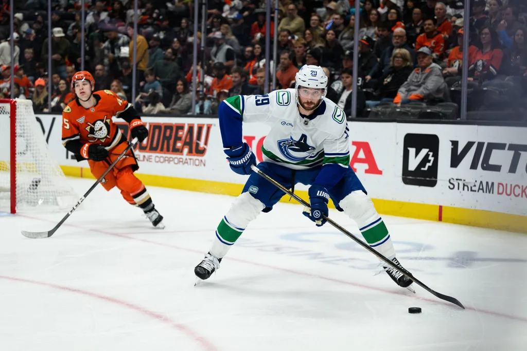 Nov 26, 2025; Anaheim, California, USA; Vancouver Canucks defenseman Marcus Pettersson (29) controls the puck during the second period against the Anaheim Ducks at Honda Center. Mandatory Credit: William Liang-Imagn Images