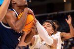 Nevada Wolf Pack guard Corey Camper Jr. (4) fights for a rebound against Washington Huskies guard JJ Mandaquit (23) during the first half of their game in the Acrisure Series in Palm Desert, Calif., Thursday, Nov. 27, 2025.