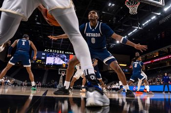 Nevada Wolf Pack guard Chuck Bailey III (0) defends a Washington Huskies players as he throws in the ball during the second half of their game in the Acrisure Series in Palm Desert, Calif., Thursday, Nov. 27, 2025.