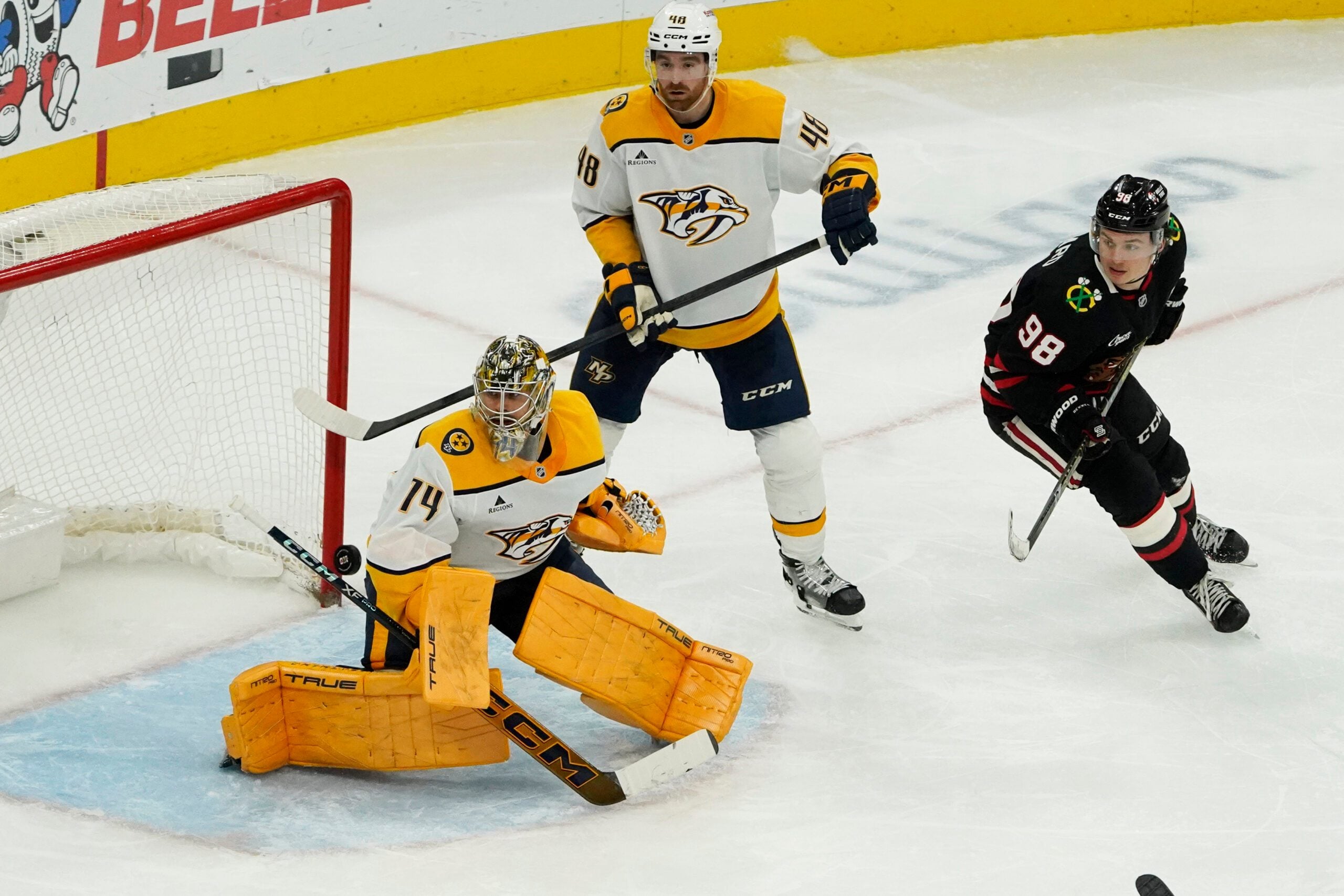 Nov 28, 2025; Chicago, Illinois, USA; Nashville Predators goaltender Juuse Saros (74) makes a save as Chicago Blackhawks center Connor Bedard (98) follows the puck Nashville Predators goaltender Juuse Saros (74) during the third period at United Center. Mandatory Credit: David Banks-Imagn Images